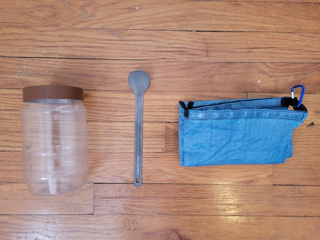 From left to right, top to bottom: JIF peanut butter jar, Sea To Summit long handle titanium spoon, Zpacks large food sack w/ carabiner