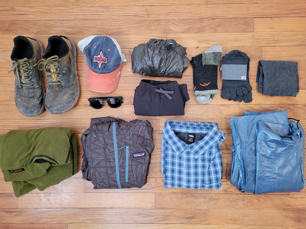 From left to right, top to bottom: Altra Superior 4.0, Voyageur Brewing trucker hat, SunSki sunglasses, Enlightened Equipment Copperfield 10D wind pants, Patagonia Ninetails shorts, Darn Tough socks, Injinji toe socks, merino wool Buff, Melanzana microgrid fleece hoodie, Patagonia Houdini, REI Sahara, Frog Toggs emergency poncho